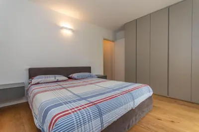 a bedroom with a bed with two pillows on it at La Casa di Sofia in Alleghe