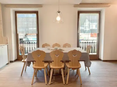 a dining room with a table and chairs at Cesa Do Ruf eurochalet in Campitello di Fassa