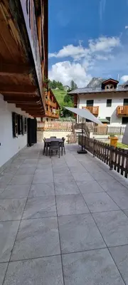 a patio with a picnic table on a building at Residence Rosental in Alleghe