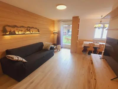 a living room with a couch and a table at Cuore delle Dolomiti - Alpine Stay Apartments in Ziano di Fiemme