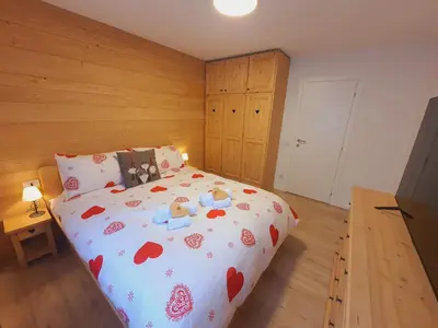 a bedroom with a bed with teddy bears on it at Cuore delle Dolomiti - Alpine Stay Apartments in Ziano di Fiemme