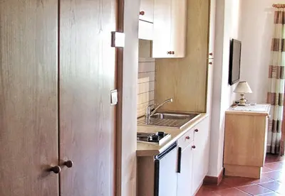 a small kitchen with a sink and a counter top at Ferienwohnungen Günzelgut in Lana