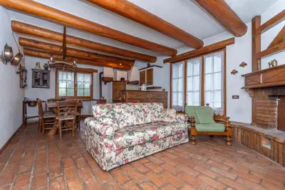 a living room with a couch and a table at Tabia Maredane in Falcade