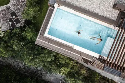 a building with a mountain in the background at Stoa - Elegant & Romantic Guest House - 