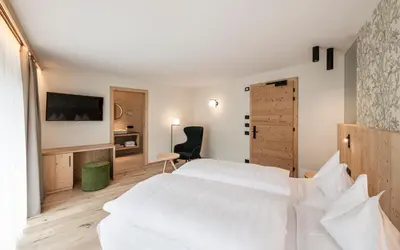 a bedroom with a large white bed and a desk at Stoa - Elegant & Romantic Guest House - 