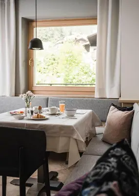 a table with plates of food on it next to a window at Stoa - Elegant & Romantic Guest House - 