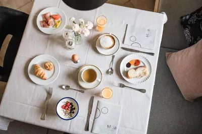 a table with breakfast foods and coffee on it at Stoa - Elegant & Romantic Guest House - 