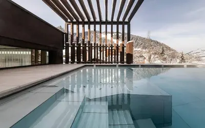 two people in a swimming pool on top of a building at Stoa - Elegant & Romantic Guest House - 