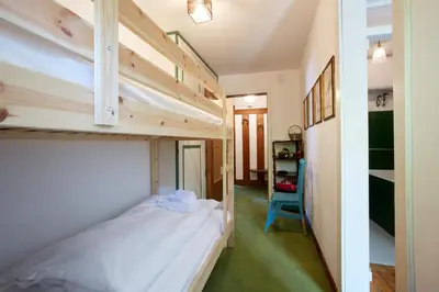 a small bedroom with a bunk bed and a hallway at Lioda Castle in Cortina dʼAmpezzo