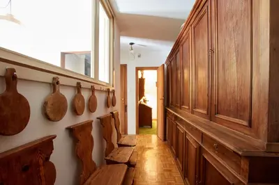 a hallway with wooden cabinets and vases on the wall at Lioda Castle in Cortina dʼAmpezzo