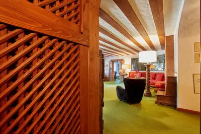 a wooden garage door in a living room with a wooden fence at Lioda Castle in Cortina dʼAmpezzo
