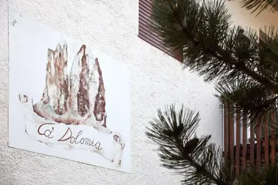 a picture of a hand on a wall with a christmas tree at Lioda Castle in Cortina dʼAmpezzo