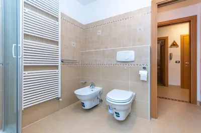 a bathroom with a toilet and a sink at Casa Erica in Falcade