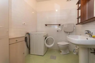 a bathroom with a toilet and a sink at Casa Erica in Falcade