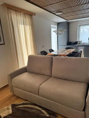a living room with a couch and a table at Cesa Balzan in Canazei