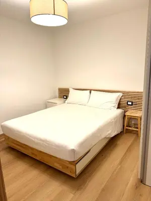 a bedroom with a large bed with white sheets at Cesa Balzan in Canazei