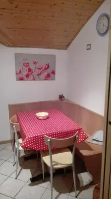 a table with a pink polka dot table cloth at Silvano Fanti in Rumo
