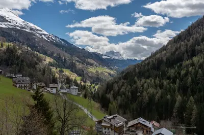 a village in a valley with snow covered mountains at Arabba - Al Vecio Soler in Livinallongo del Col di Lana