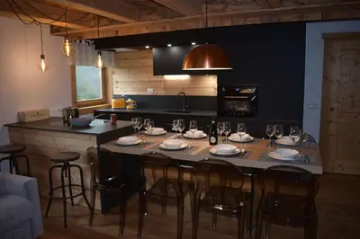 a dining room table with chairs and wine glasses at Arabba - Al Vecio Soler in Livinallongo del Col di Lana