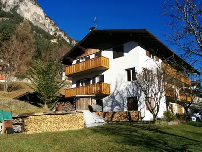 a house in the mountains with a balcony at Casa Defrancesco in Panchia