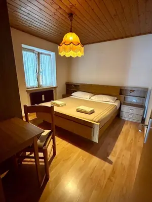 a bedroom with a wooden cabinet and a radiator at Casa Defrancesco in Panchia