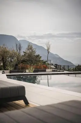 a swimming pool with a view of the mountains at SomVita Suites in Tirolo