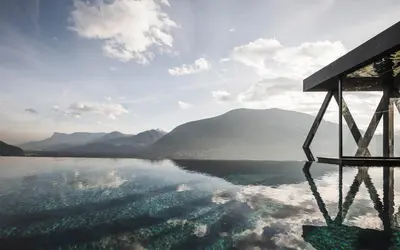 a view of a body of water with mountains in the background at SomVita Suites in Tirolo