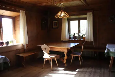 a dining room with a wooden table and two chairs at mösslerhof in Aldino