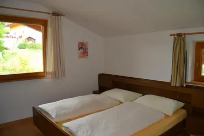a bedroom with two beds and a window at Residence Rastbichl - Apartments & Indoor-Pool in Maranza
