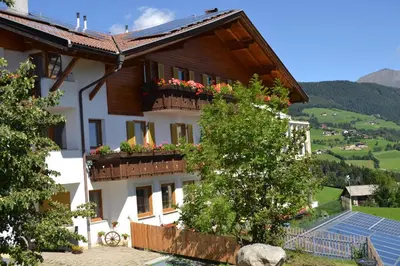 a building with flower boxes on the balconies at Residence Rastbichl - Apartments & Indoor-Pool in Maranza