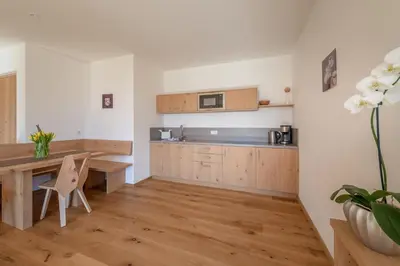 a room with two chairs and a table and windows at Moosbichlerhof in Marlengo