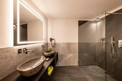 a bathroom with a sink and a shower at Apartments Aois 4 Elements Suites in La Valle