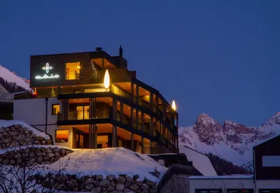 a building in the middle of a snowy mountain at Apartments Aois 4 Elements Suites in La Valle