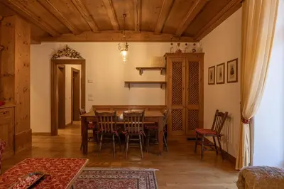 a dining room with a table and chairs at Casa Ciclamino, direttamente sul Corso di Cortina dAmpezzo in Cortina dʼAmpezzo