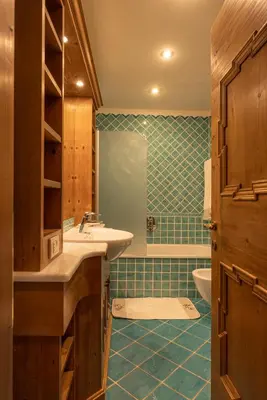 a bathroom with a sink and a tub at Casa Ciclamino, direttamente sul Corso di Cortina dAmpezzo in Cortina dʼAmpezzo