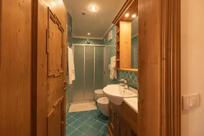 a bathroom with a toilet and a sink at Casa Ciclamino, direttamente sul Corso di Cortina dAmpezzo in Cortina dʼAmpezzo