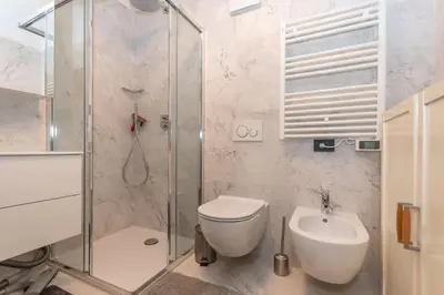 a bathroom with a shower and a toilet and a sink at Casa Ciadenac in Soraga