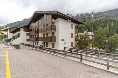 a building with a balcony on the side of a road at Casa Ciadenac in Soraga