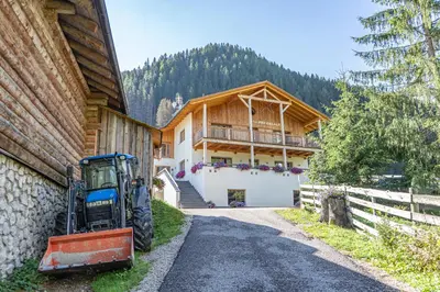 a tractor is parked in front of a house at Apartements Precalalt in La Villa