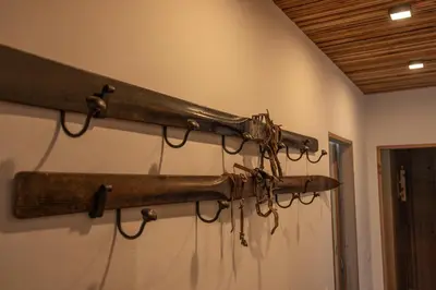 a gun hanging on a wall in a room at Casa Bucaneve, con terrazza panoramica sulle Dolomiti in Cortina dʼAmpezzo