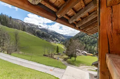 a view from a house window of a mountain at El Maso - Arabba in Livinallongo del Col di Lana