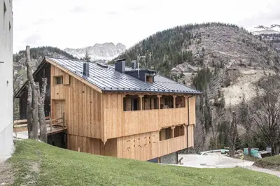 a wooden house on top of a hill at Tabià del Belli in Livinallongo del Col di Lana