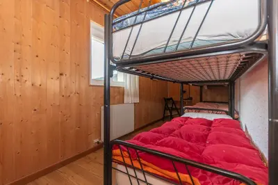 a bedroom with a bunk bed in a room at Casa Bristol in Pozza di Fassa