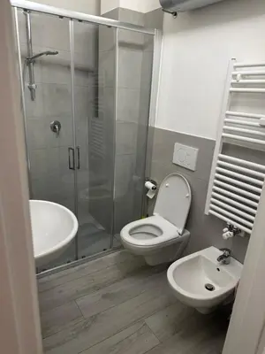 a bathroom with a shower and a toilet and a sink at Ida s home free WiFi AC in Bolzano