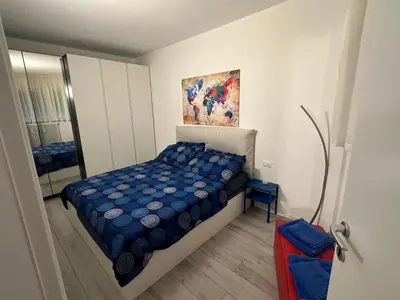 a small bedroom with a bed and a mirror at Ida s home free WiFi AC in Bolzano