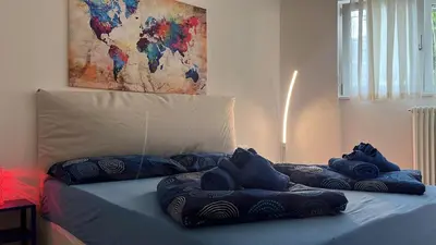 a bed with blue pillows on top of it at Ida s home free WiFi AC in Bolzano
