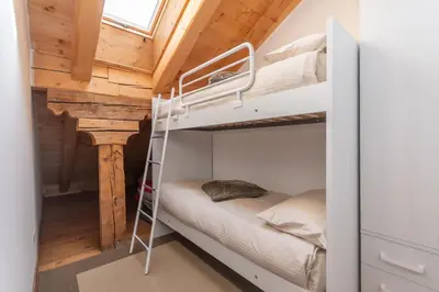 a bedroom with a bed and wooden ceilings at AE 1793 - Arabba in Livinallongo del Col di Lana