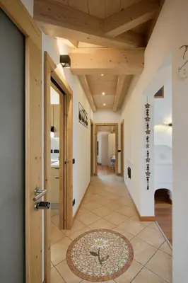 a hallway with a wooden ceiling and a door at Apartment Alpen Dolomites in Selva di Cadore