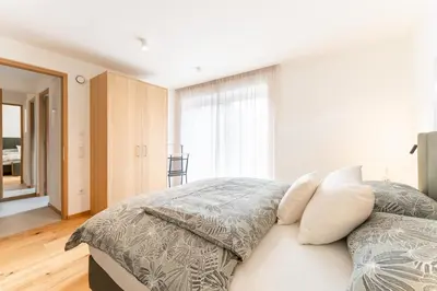 a bedroom with a bed with pillows on it at Villa Julia in Lana