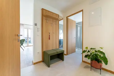 a hallway with a green bench next to a door at Villa Julia in Lana